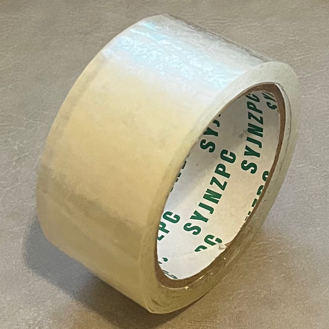 This photo of tape was taken at a 45-degree angle. The tape is standing. Both its inside and outside is visible. It's consider as a torus.